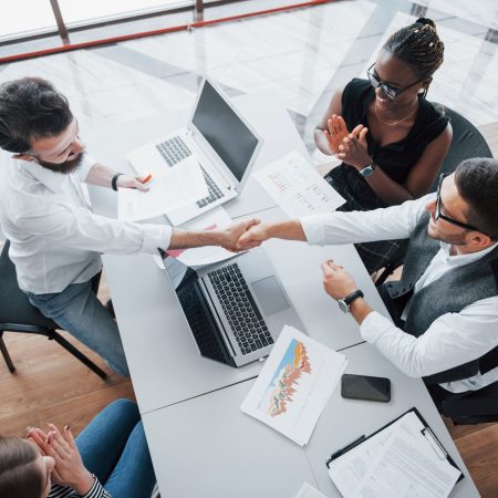 young-employees-sitting-office-table-using-laptop-team-work-brainstorming-meeting-concept
